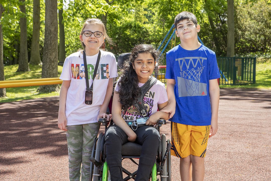 Group of 3 Disabled students, the girl in the middle being in a wheelchair