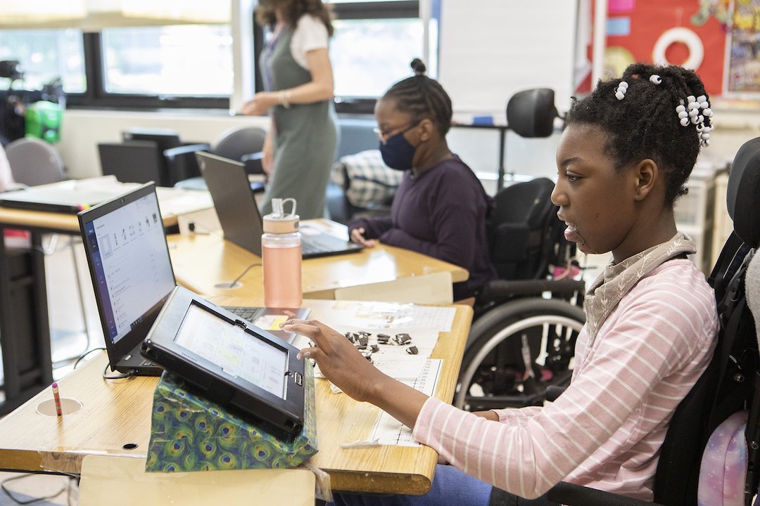 Special Needs student in wheelchair at tablet learning